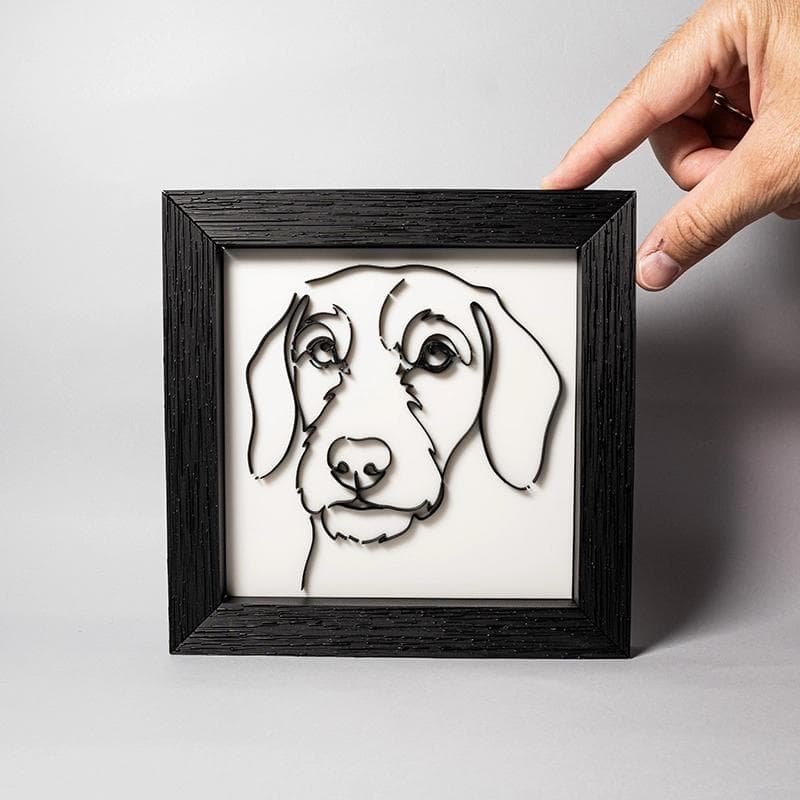 Cuadro teckel line art mostrado junto a objetos para apreciar sus dimensiones